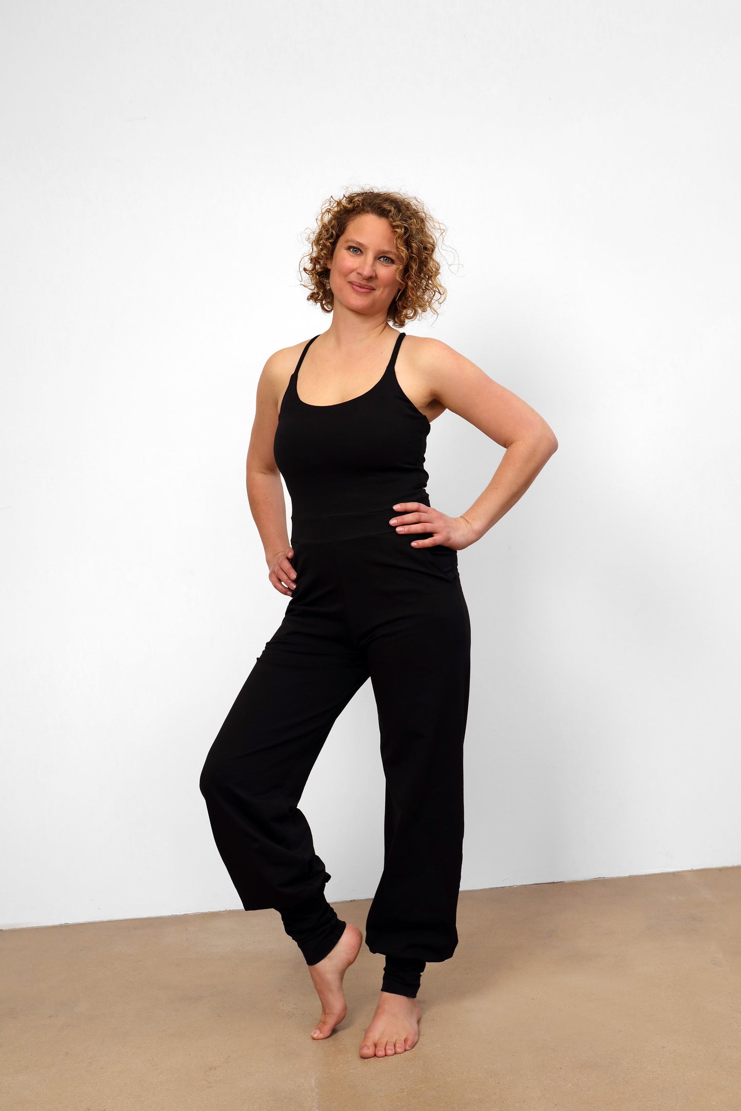 yoga jumpsuit nashira by breath of fire color black sustainable wear front view