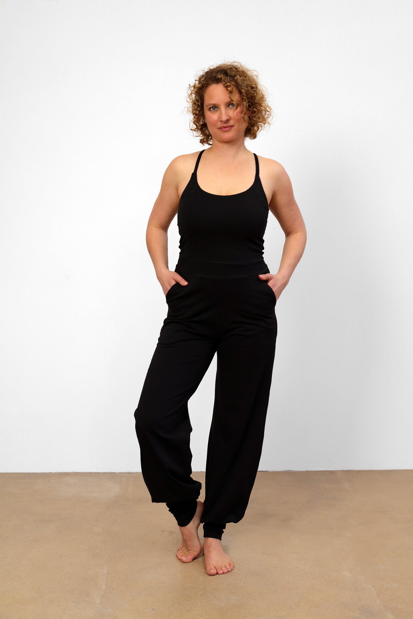 yoga jumpsuit nashira color black by breath of fire sustainable yoga fashion front view