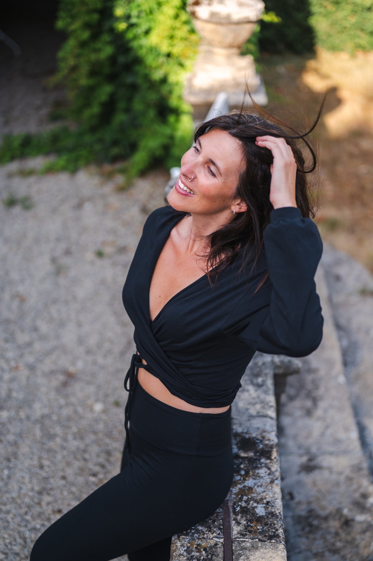 Breath of Fire Talya wrap shirt — Black — lifestyle photo, wrap silhouette in natural light